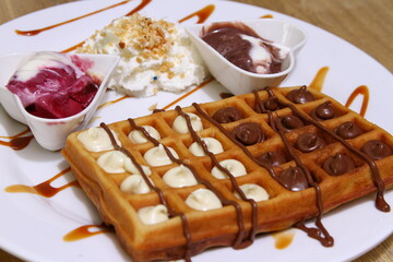 Belgian waffle with white chocolate and brown chocolate and whipped cream