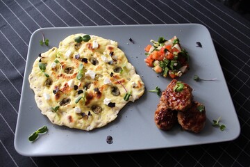 Greek grill meatball on pita with tomato and cucumbers