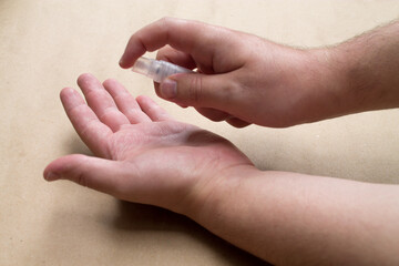 A man applying antibacterial gel on his left hand.