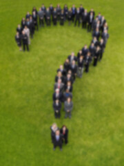 Blurred group of business people in question mark shape