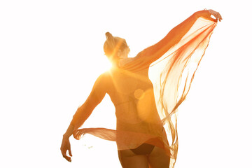 Woman dancing in park with strong sunshine