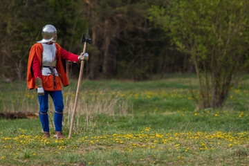 Knights in armor fight on the battlefield. Reconstruction of an ancient battle of the 15th century.