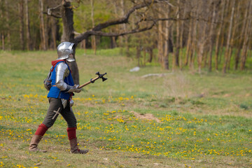 Knights in armor fight on the battlefield. Reconstruction of an ancient tournament of the 15th...