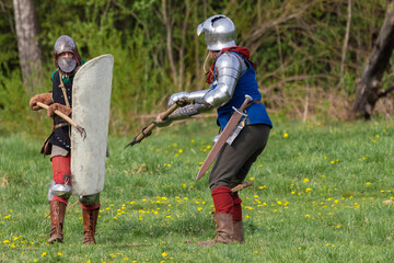 Details of the ancient uniform of knights in armor and helmets, the era of the 15th century.