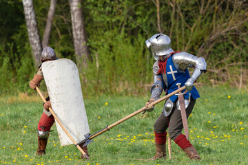 Details of the ancient uniform of knights in armor and helmets, the era of the 15th century.