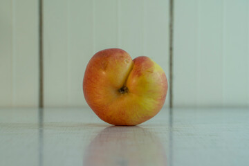 Weirdo siamese twins apple lie on the table and reflexed in it. Organic fruit is good for diet because contain a lot vitamins and microelements. Landscape image with copy space.