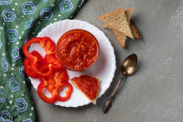 Homemade aivar sauce on a black board, top view. Balkan cuisine. Horizontal orientation