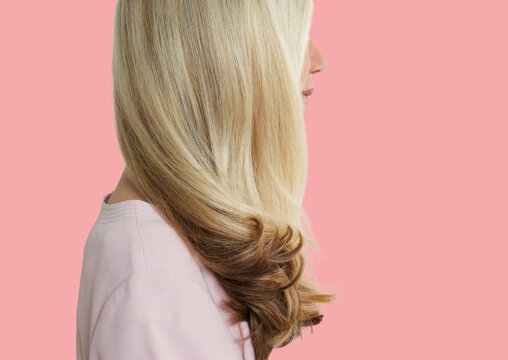 Senior Woman With Long Blonde Hair Standing Over Pink Background