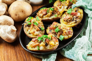 Baked potatoes in jacket stuffed with bacon, mushrooms and cheese. Dish served in baking dish..Baked potatoes stuffed with bacon, mushrooms and cheese