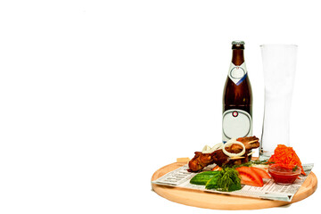 Food with a place for photos. A barbecue and a bottle of beer are on the serving Board. Image with selective focus and noise. 