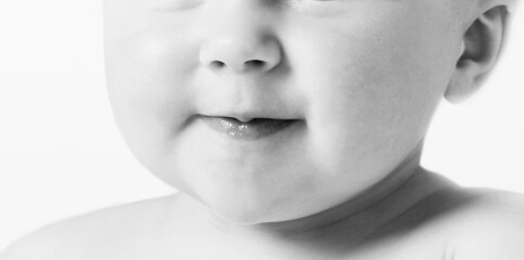 Cropped black and white photo of baby mouth
