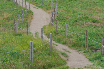 Fototapeta premium The footpath in the Basque Country in summer sunny day. Green landscape. Freshness and calmness in the nature. Concepts of the beauty of nature and healthy lifestyles. Ecological trip theme.