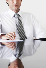 Cropped photo of businessman sitting at table in office