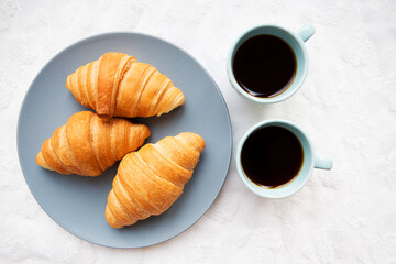 cup of coffee with croissant