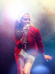 Young female rockstar Singing in Concert