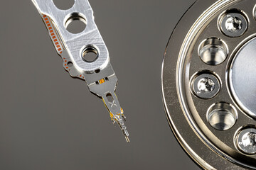 Macro shot of a magnetic needle on a hard disk platter, open HDD disk, perfectly clean surface, top...