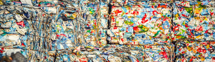 Fototapeta na wymiar Recycling and storage of waste for further disposal, trash sorting. Picture of recycled plastic waste pressed to bales. Plastic bottles,compressed