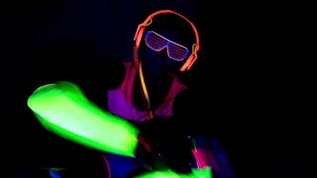 Person wearing neon clothes raving in club