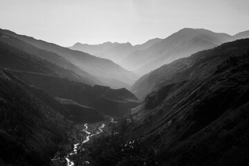Fototapeta na wymiar Layers of black and white backlit mountains