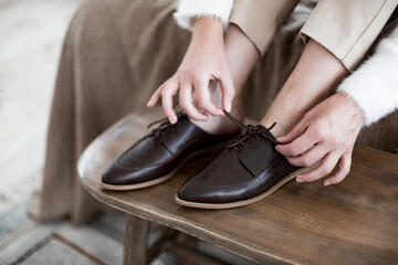 fashionable women's shoes, feet in the interior, classic women’s flat shoes, brown leather shoes,...