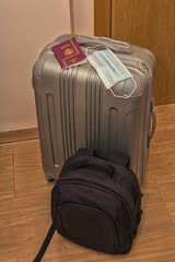 Travel luggage to travel outside of Spain, with a Spanish passport and a health mask, so as not to be infected by Coronavirus. Covid-19. Travels