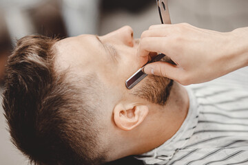 Barber beard styling and cut process. Barbershop for men