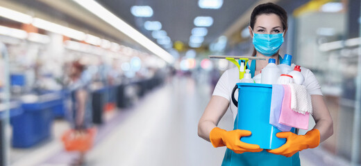 A cleaning lady shows a cleaning tool and a cleaning agent .