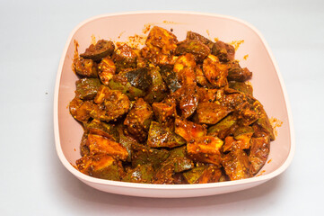 Mango pickle in the plastic bowl
