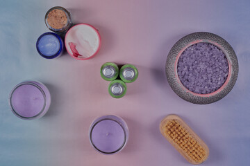 Flat lay image of some bathroom products on a pastel coloured background.