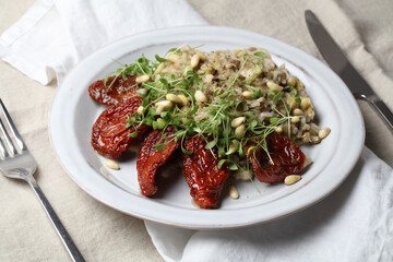 Braised brown rice, sprouted lentils and coconut milk with sun-dried tomatoes, micro-greens and pine nuts