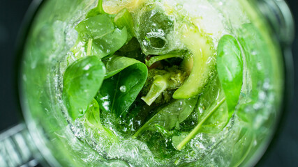 Green fresh smoothie blended in blender, top view. Healthy eating concept.