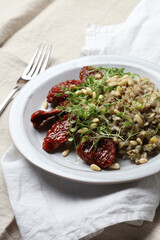 Braised brown rice, sprouted lentils and coconut milk with sun-dried tomatoes, micro-greens and pine nuts
