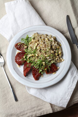 Braised brown rice, sprouted lentils and coconut milk with sun-dried tomatoes, micro-greens and pine nuts