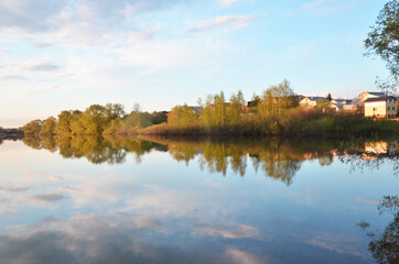 Beautiful colorful sunset over Lake in the forest or park with tree
