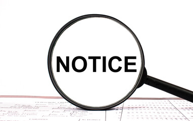 Magnifying glass with text NOTICE on financial tables
