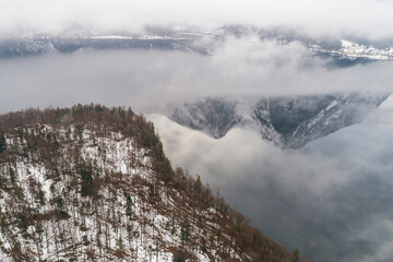Aerial drone view of  foggy Obertraun mountains Hallstatt in Salzkammergut, Austria in Winter