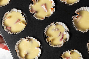 Cooking Homemade muffins with red berries and cherries