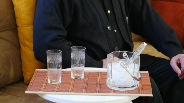 Old man waiting to be served at home. RAKI similar to several other alcoholic beverages available around the Mediterranean and the Middle East. In Turkey and Greece, it is considered a national drink.