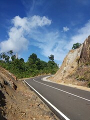 the view on the hill with blue sky and asphalt road