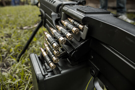 M249 light machine gun with 7.62 mm cartridge belt black and white