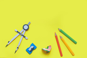 Back to school. Handmade paper art and cutout tools. Set of pencils, sharpener and compass. Copy space. 