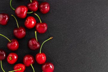 cherry on dark background with copy space. Top view. Flat lay