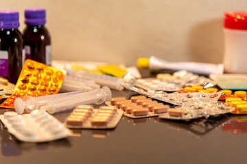 Remedies and medicine cards spread on mirrored and blurred surface