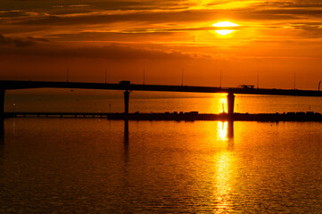 Fototapeta na wymiar Bridge on the Sunset over the sea in Russia