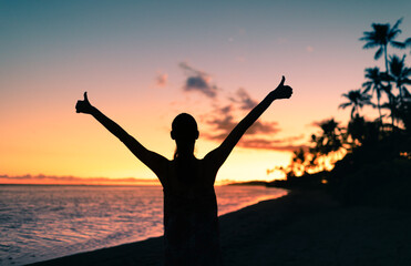 Fototapeta premium Happy girl on the beach feeling positive making thumbs up gesture. 