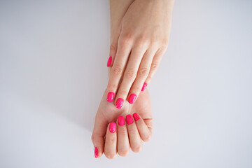 Beautiful female hands. Beautiful manicure on a white background. Beauty and skin care concept, flat lay.