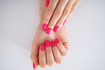 Beauty and skin care concept, close-up. Beautiful female hands and beautiful manicure on a white background, flat lay.