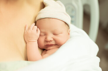 Newborn baby lying on mothers chest. Baby birth concept. 