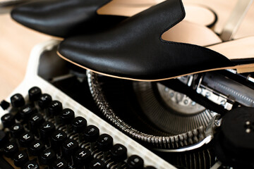shoes and typewriter on a wooden table, atmosphere of a woman traveler journalist or blogger