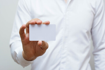 Man with a white card for copy-space. Business card concept.